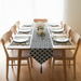 Black and white geometric lattice table runner with matching placemats.