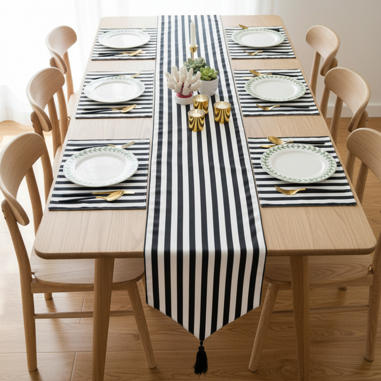 Narrow black and white striped table runner with matching placemats.