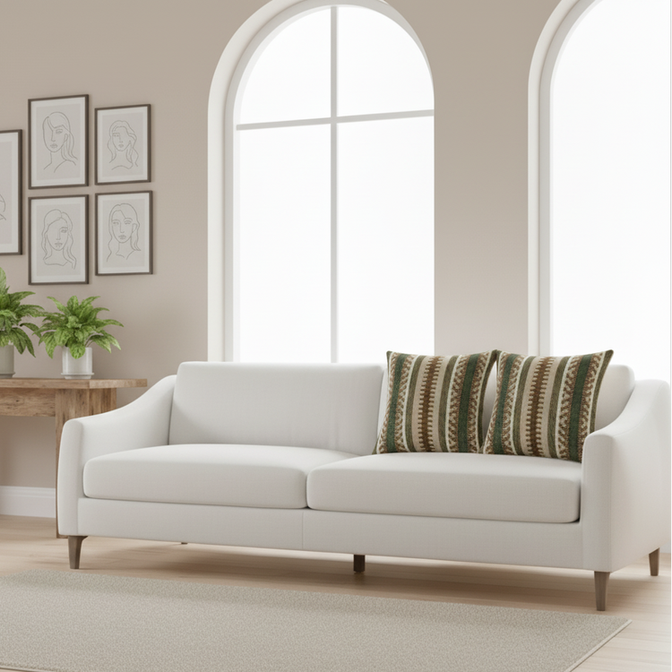 Two striped cushion covers in earthy green and brown tones on a cream sofa.