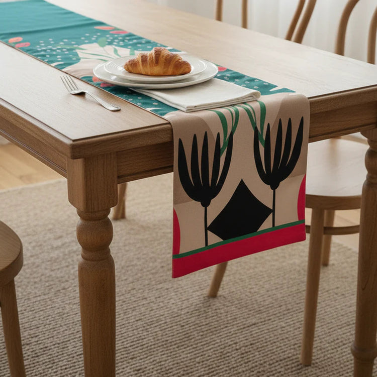 Abstract botanical table runner with black, turquoise and pink motifs.
