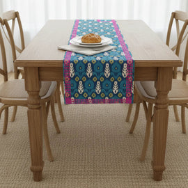 Blue floral medallion table runner with pink patterned borders.