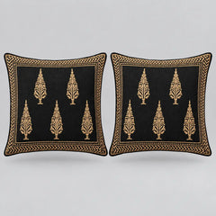 Two square black throw pillows with gold embroidered tree motifs and a decorative gold border, shown side by side on a light gray background.