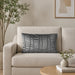 Rectangular silver grey filled cushion with vertical stitched texture on a cream sofa.