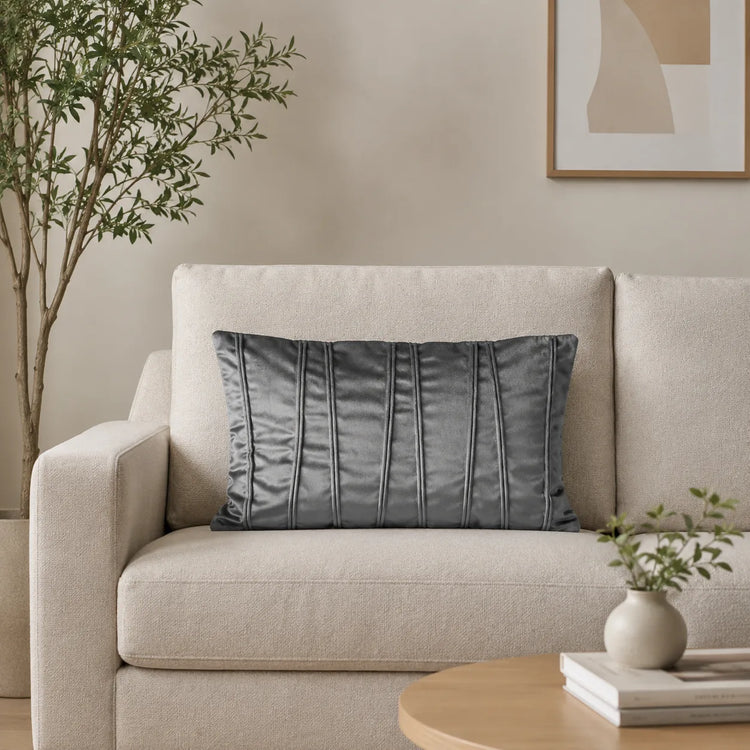 Rectangular silver grey filled cushion with vertical stitched texture on a cream sofa.