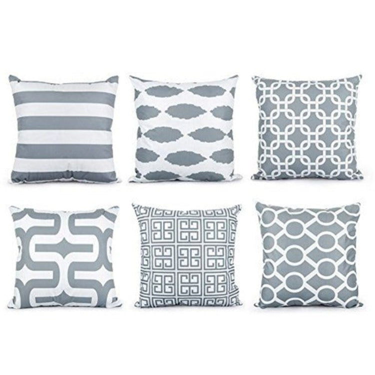 Six grey and white cushion covers with stripes and interlocking geometric patterns.