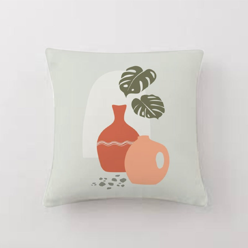 Pale green cushion cover with orange pots and green leaves.