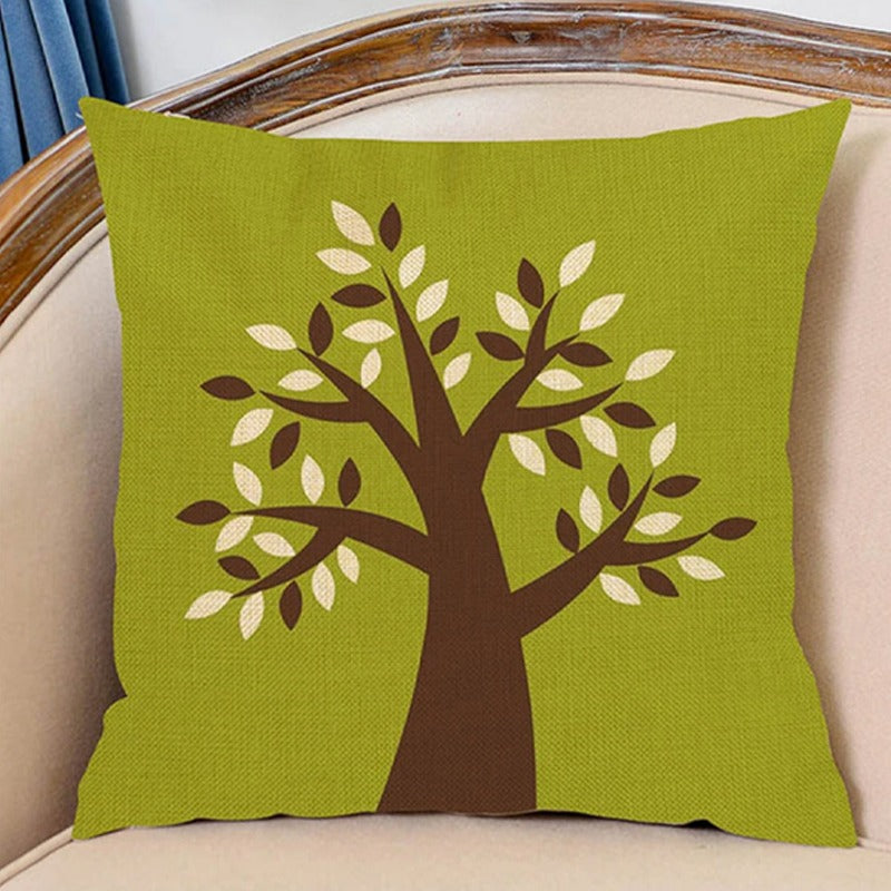 Green cushion cover with a brown tree and pale green leaves.