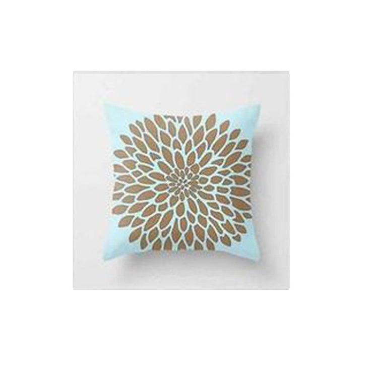 Pale blue cushion cover with a large tan and cream radial flower pattern.