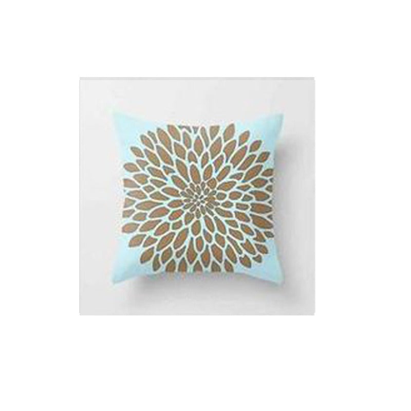 Pale blue cushion cover with a large tan and cream radial flower pattern.