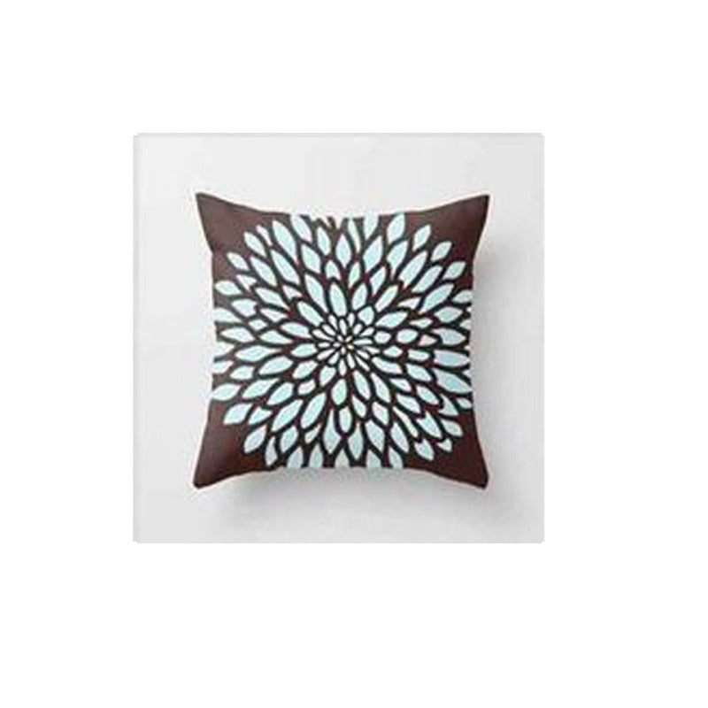 Brown cushion cover with a large pale blue radial flower pattern.