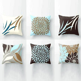 Six brown, cream and pale blue cushion covers with leaf and flower patterns.