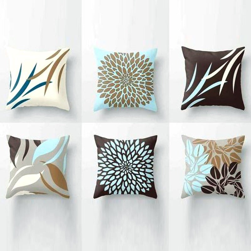 Six brown, cream and pale blue cushion covers with leaf and flower patterns.