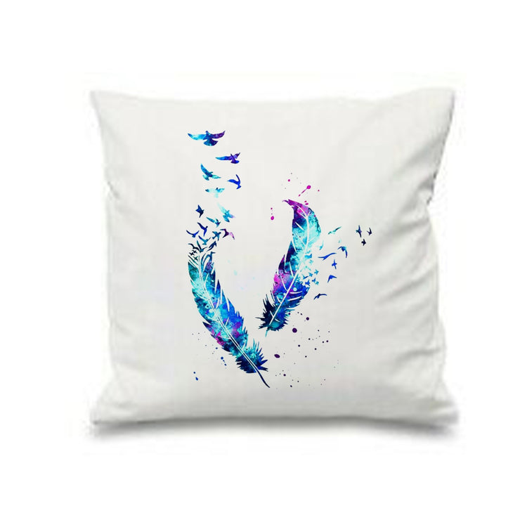 White cushion cover with two blue and purple feathers dissolving into small triangles.