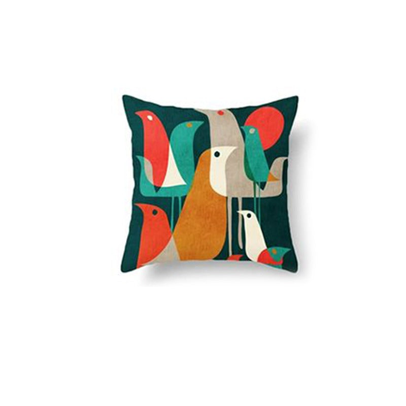 Dark green cushion cover with tall abstract shapes in orange, cream and teal.