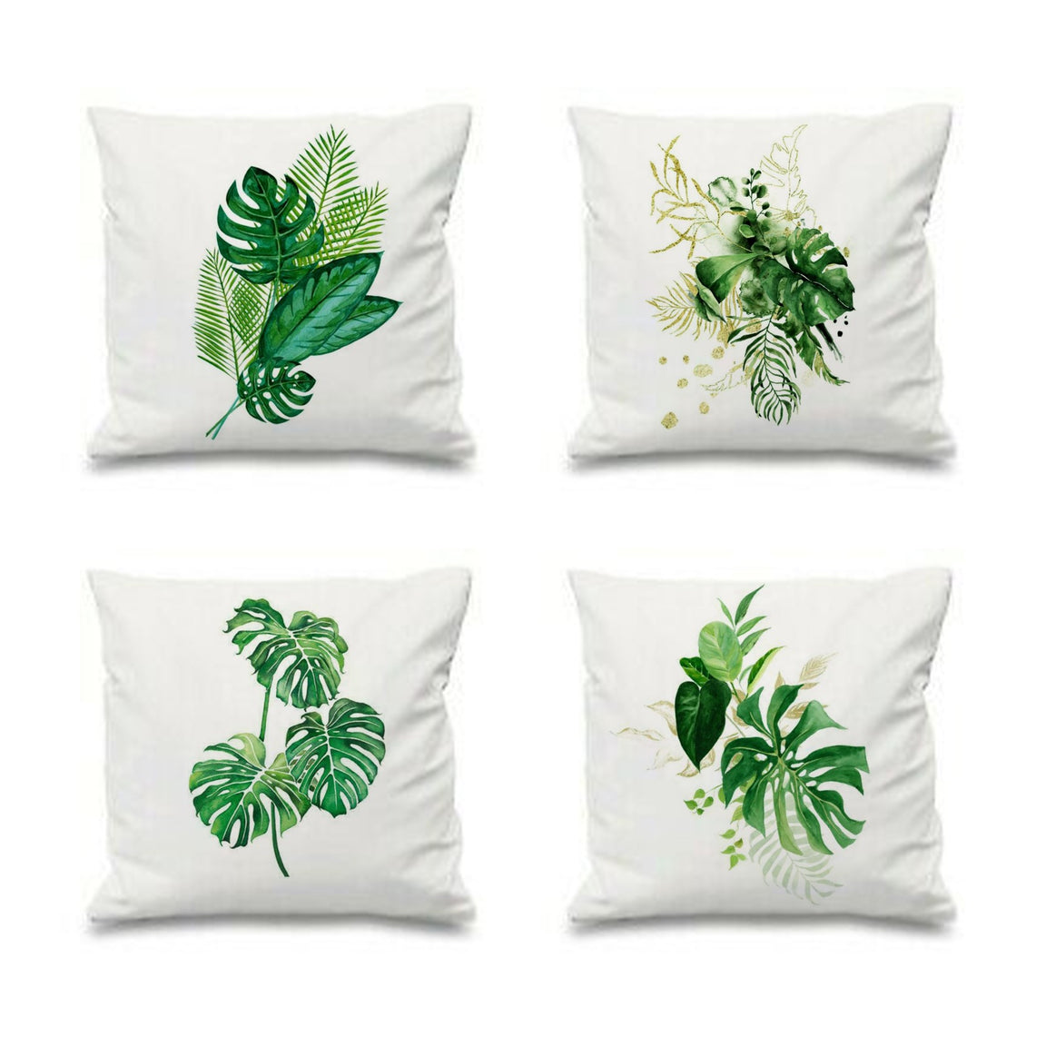 Four white cushion covers with different green tropical leaf arrangements.