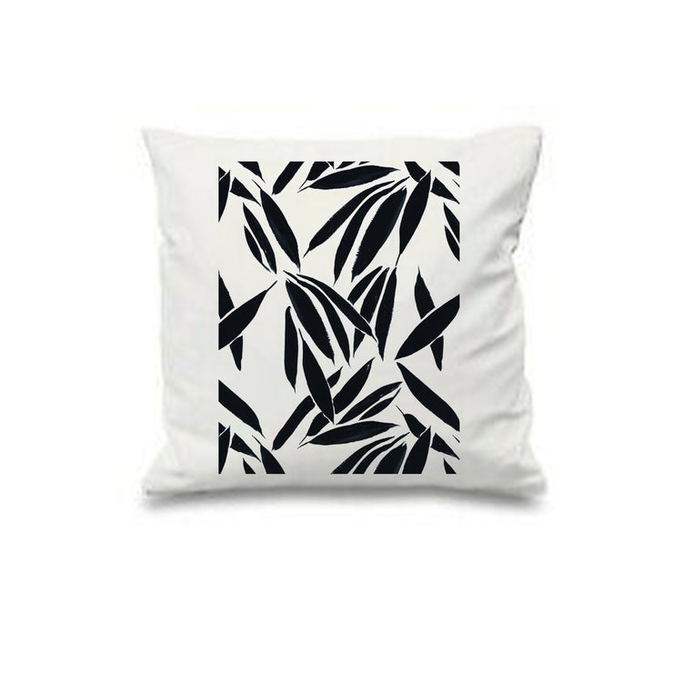 White cushion cover with a repeating black bamboo-like leaf pattern.