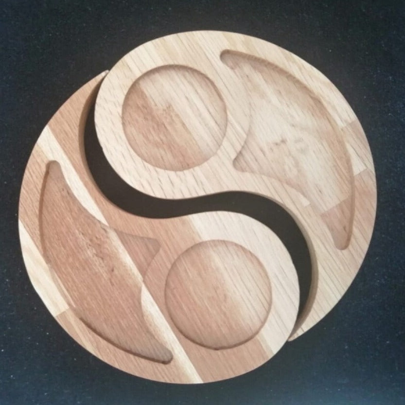 Two curved wood-tone snack trays arranged in a circular yin-yang shape