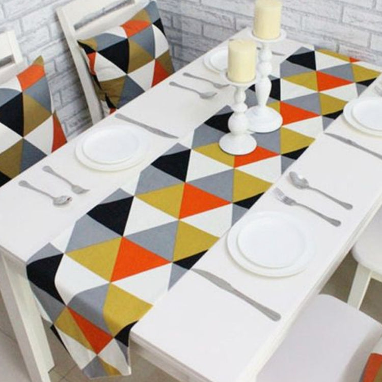 Table runner with multicoloured triangles displayed with matching patterned chair cushions.