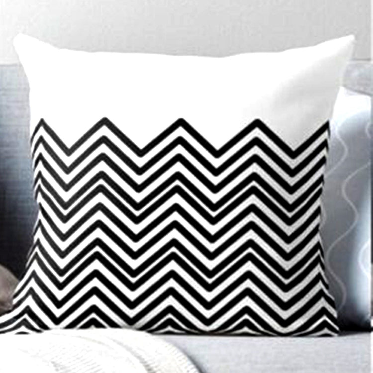 Cushion cover with black and white zigzags beneath a plain white top panel.