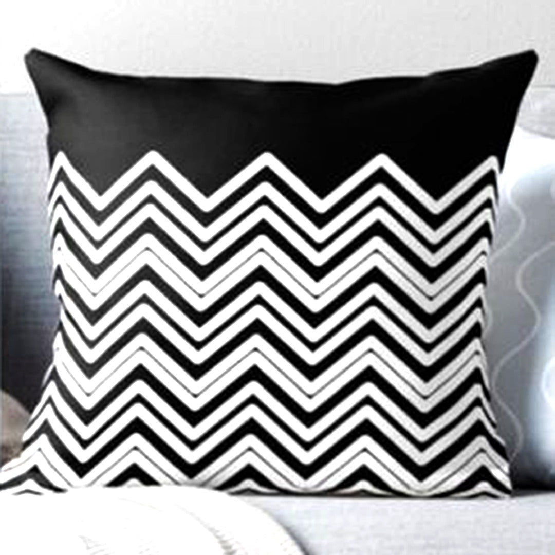 Cushion cover with black and white zigzags beneath a plain black top panel.