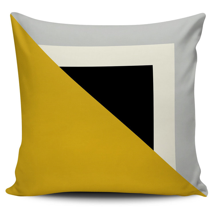 Cushion cover with a mustard triangle over nested grey, cream and black squares.