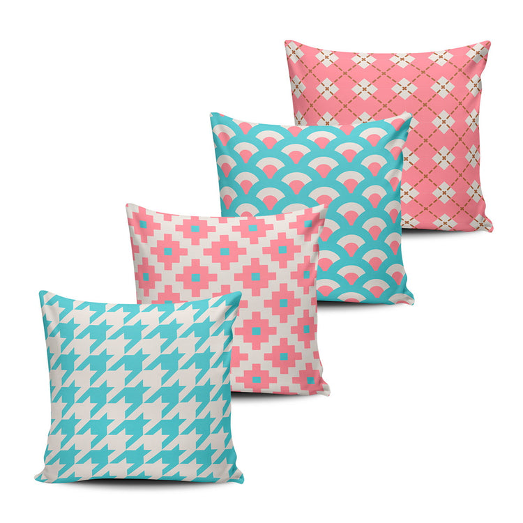 Four pink, turquoise and cream cushion covers with geometric patterns.