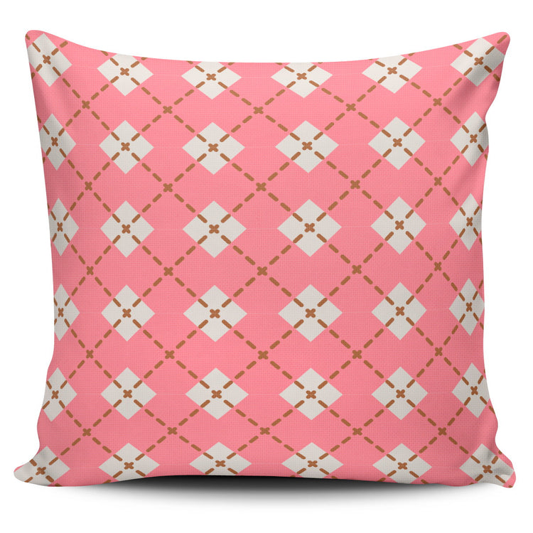 Pink cushion cover with cream diamonds and fine diagonal lines.