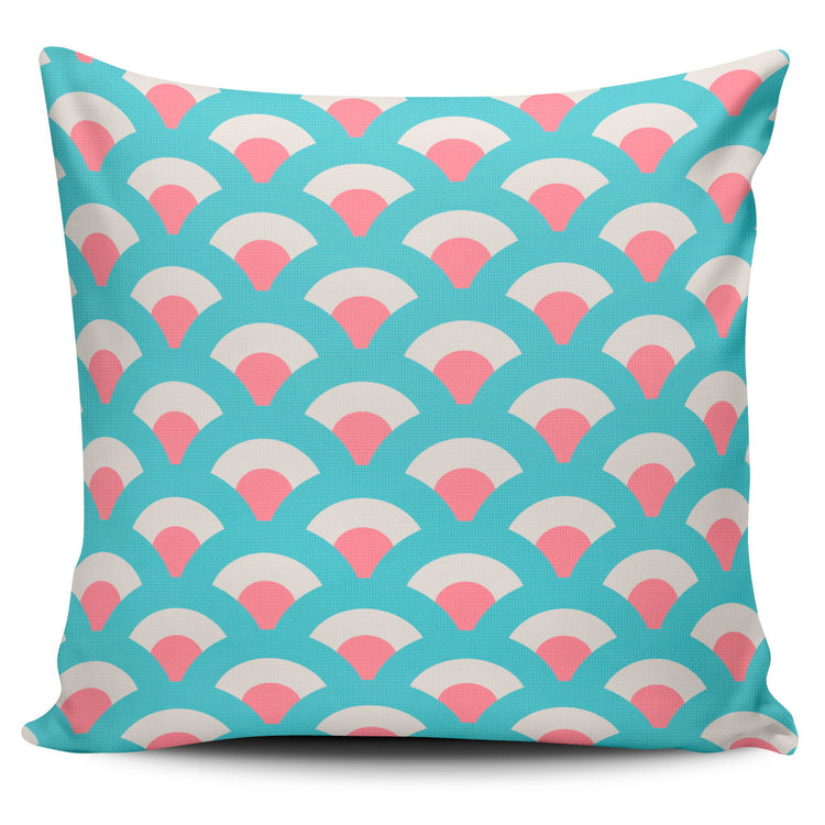 Turquoise cushion cover with repeating pink and cream fan shapes.