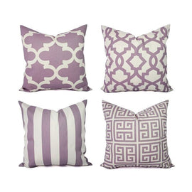 Four mauve and cream cushion covers with lattice, stripe and maze patterns.