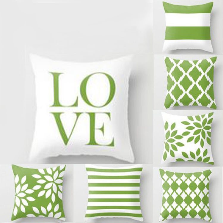 Green and white cushion covers with LOVE lettering, stripes and geometric leaf patterns.