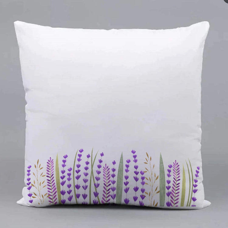 White cushion cover with purple flowering stems along the bottom edge.
