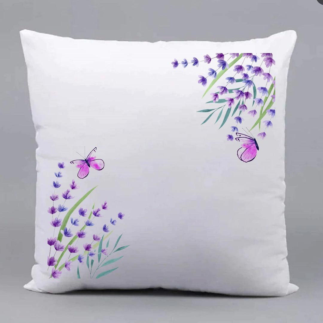 White cushion cover with purple floral sprigs in opposite corners.