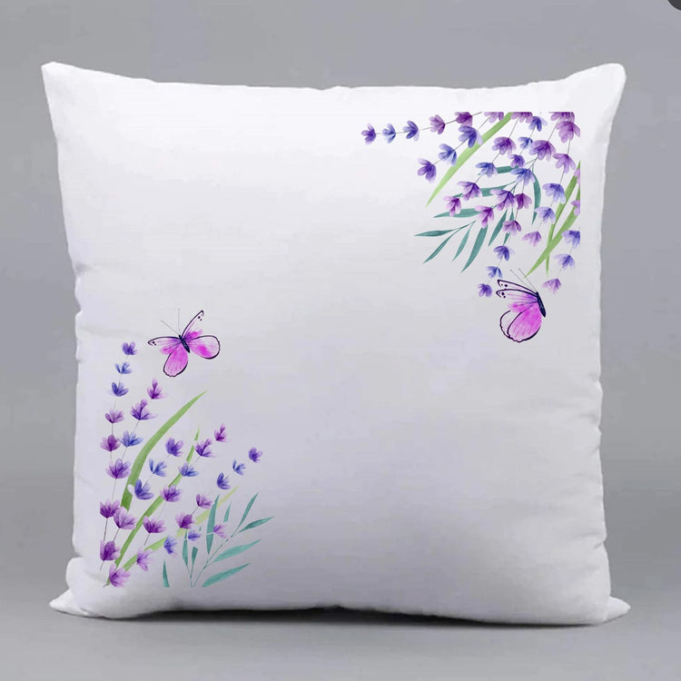 White cushion cover with purple floral sprigs in opposite corners.