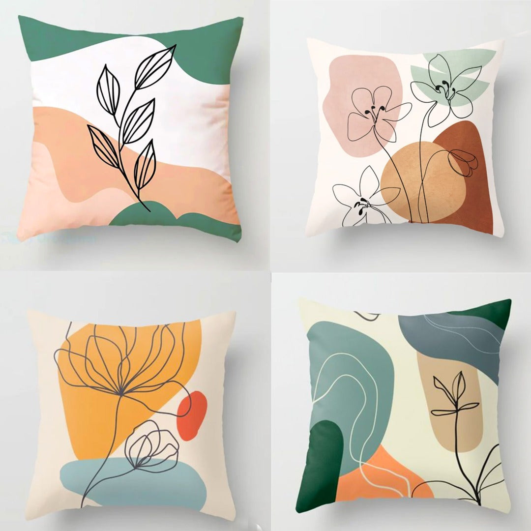 Four pastel cushion covers with botanical line drawings over abstract colour blocks.
