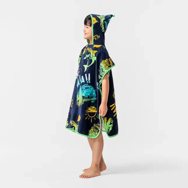 Side view of a child wearing a dark sea-life-print hooded towel poncho.