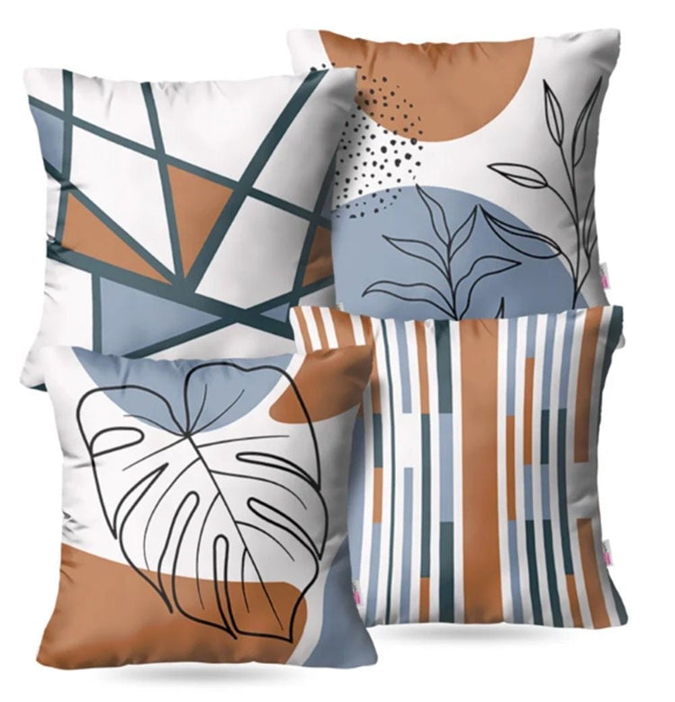 Four cushion covers with blue, rust and grey geometric, botanical and striped designs.