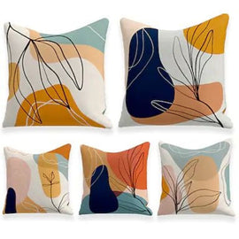 Five cushion covers with navy, mustard and pastel abstract shapes and fine looping lines.