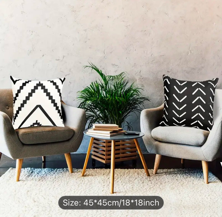 Black and cream chevron cushion covers displayed on two living room chairs.