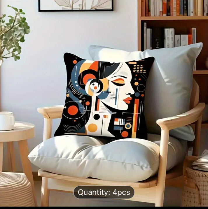Cushion cover with an abstract woman's face and orange and black details on a wooden chair.