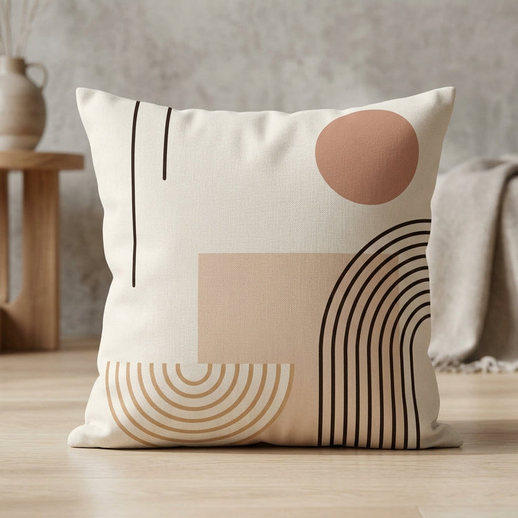 Cream cushion cover with terracotta and beige shapes and fine black curved lines.