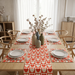 Red and cream heart-pattern table runner with matching placemats.