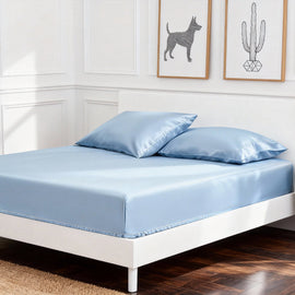 Sky blue cotton fitted sheet displayed on a double bed with matching pillowcases.