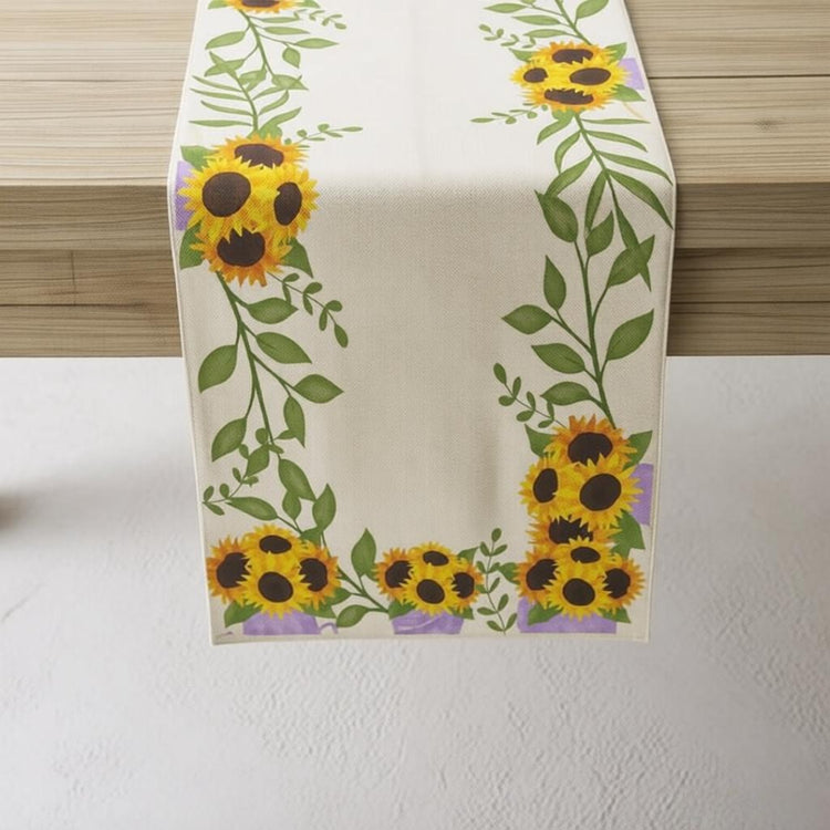 Cream table runner with yellow sunflowers and green leafy borders.