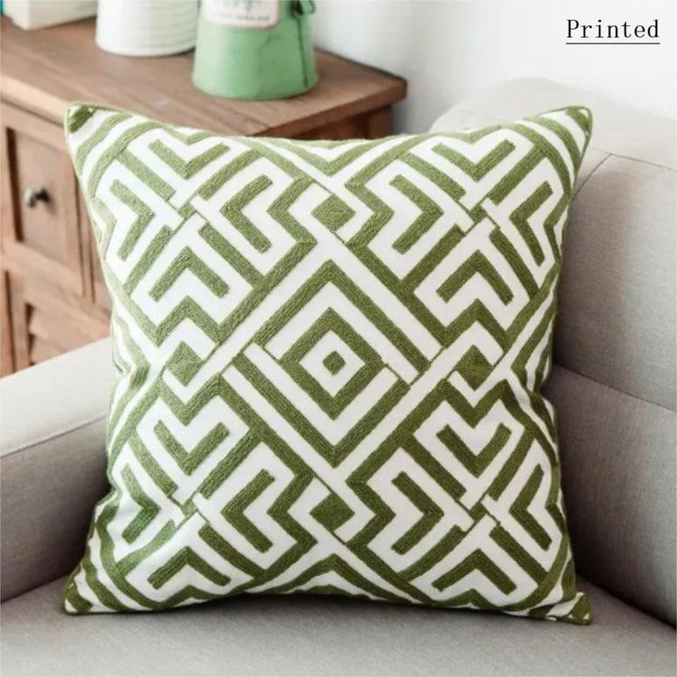 Cream cushion cover with an olive green maze-like diamond pattern.