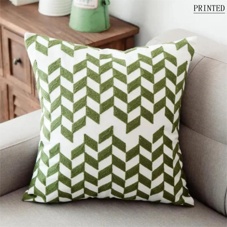 Cream cushion cover with rows of olive green chevron shapes.