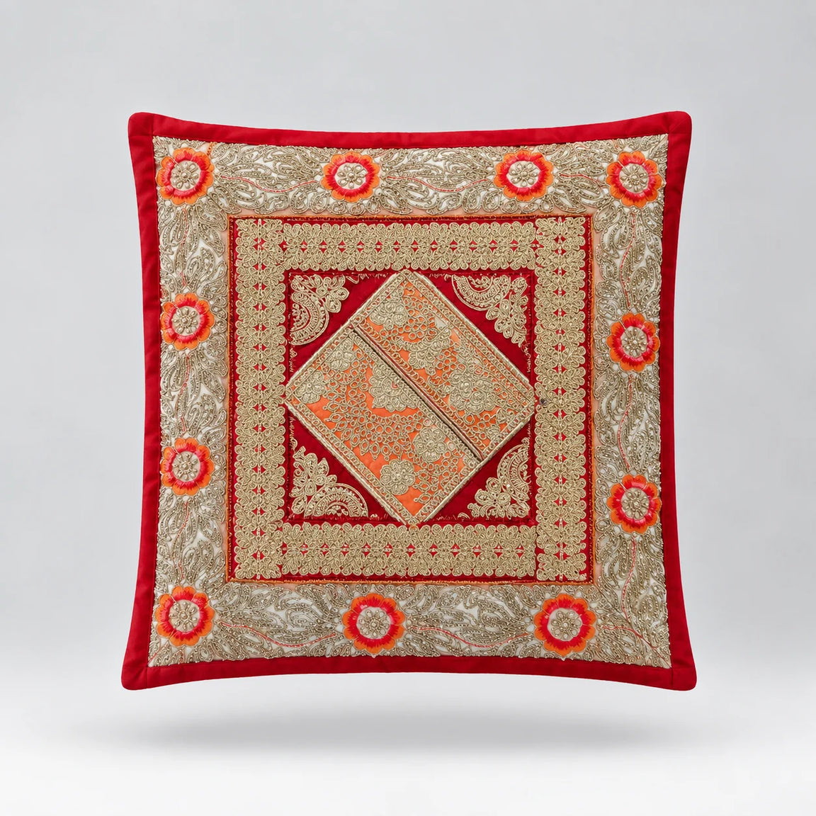 Red-bordered cushion cover with pale green ornamental bands and a large central diamond.