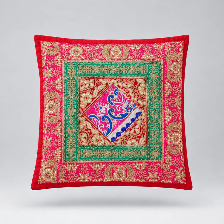 Red cushion cover with a green framed centre and a colourful ornate diamond.