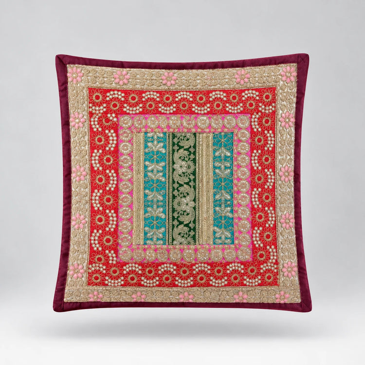 Burgundy-bordered cushion cover with a red floral field and green patterned central panel.