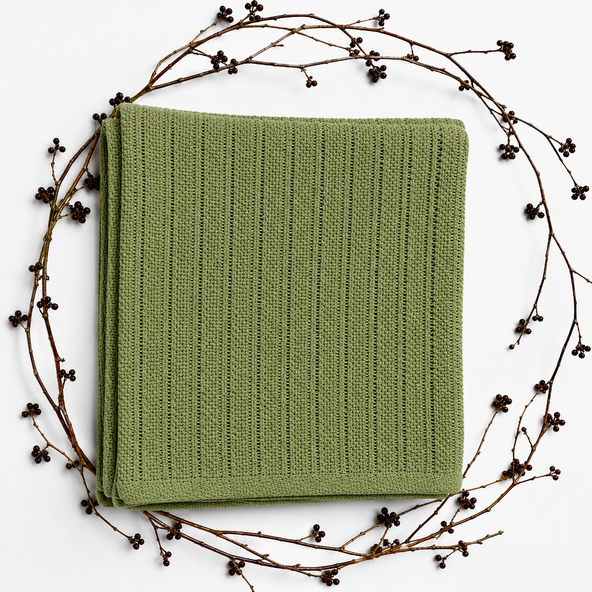 Folded sage green baby blanket with narrow vertical textured stripes and a plain border.