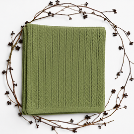 Folded sage green baby blanket with narrow vertical textured stripes and a plain border.
